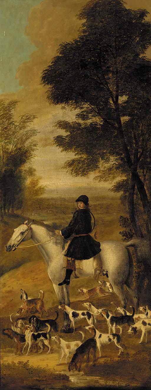 A huntsman on a grey hunter, with harriers in an extensive wooded landscape