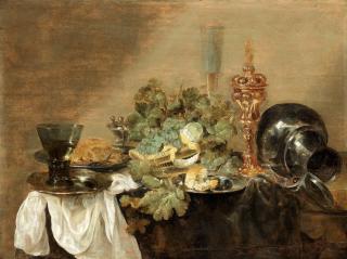 Abraham Hendricksz. van Beyeren - Grapes and a peeled lemon in a basket with bread, dressed crab and a roemer of wine on pewter plates, together with a gilt cup and cover, and a pewter flagon upon a draped table-top unframed