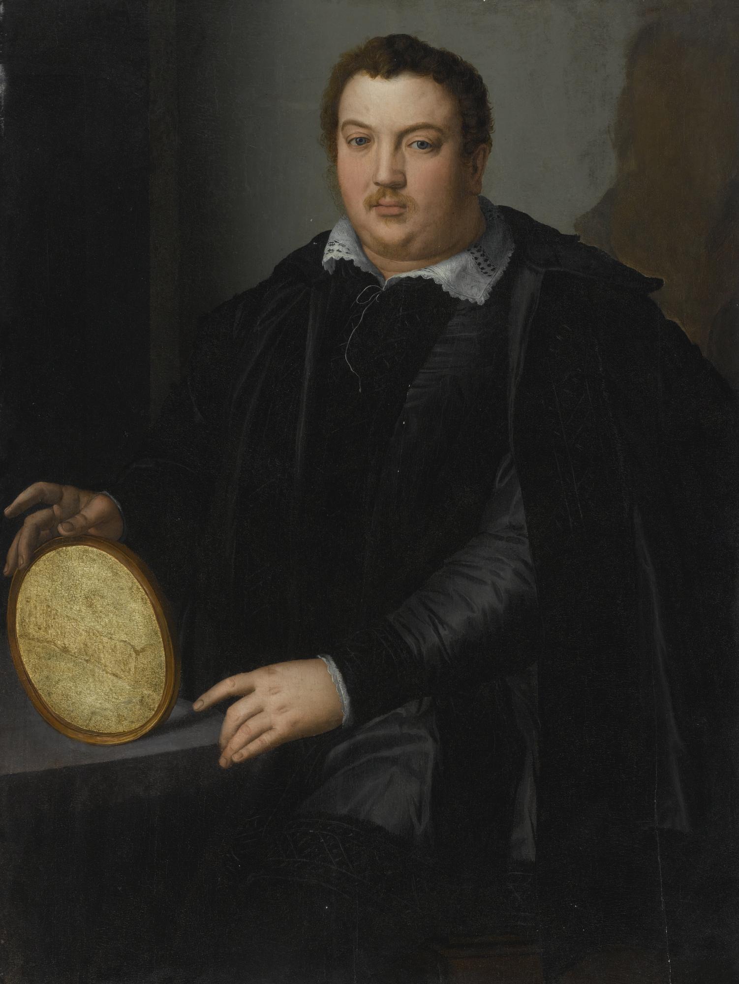 Alessandro Allori - Portrait Of A Gentleman, Three-Quarter Length, Dressed In A Black Silk Doublet And Cloak With A Blackwork Collar And Seated At A Desk, Holding An Oval Frame