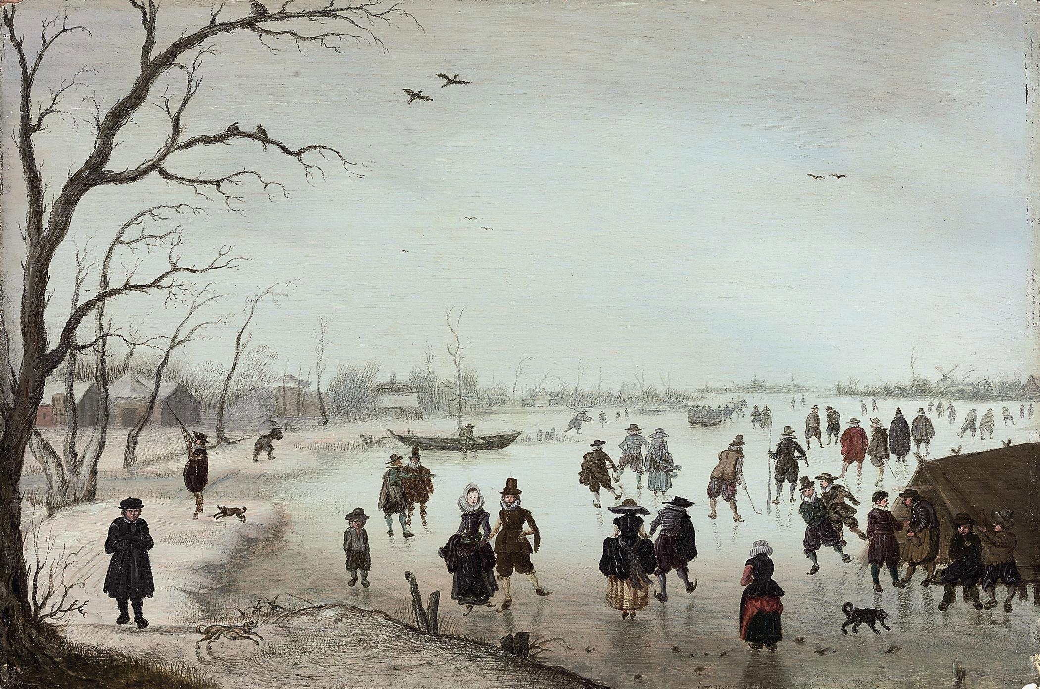Anthonie Verstraelen - A winter landscape with figures skating and making merry on a frozen river