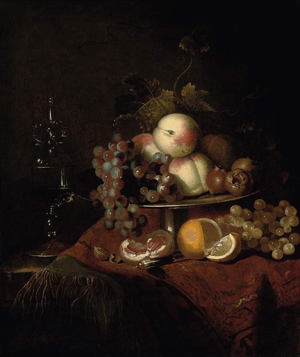 Barend van der Meer - Peaches, grapes and pomegranates on a plate, a sliced orange and walnuts on a partly draped table with a wine glass
