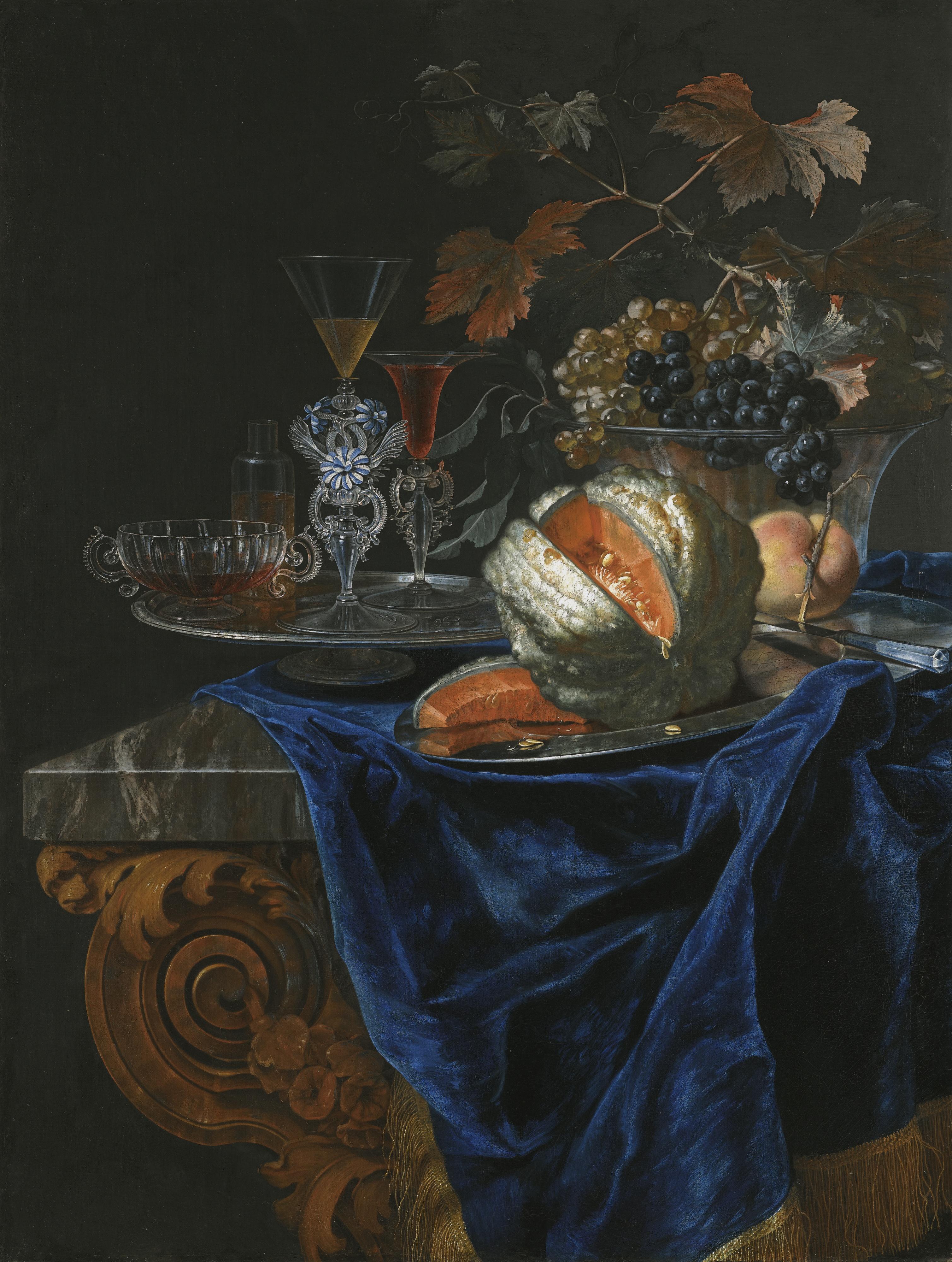 Christian Berentz - Still Life With A Melon And A Peach On A Silver Platter, Together With A Glass Bowl Of Grapes And A Tray Of Assorted Glassware On A Marble Table Top Partly Draped With A Blue Cloth