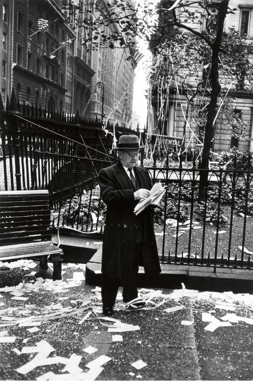 Dan Weiner - Untitled (Business man reading after a parade)
