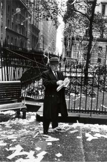 Dan Weiner - Untitled (Business man reading after a parade)