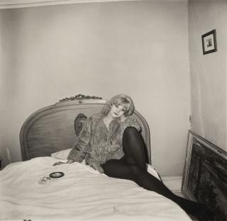 Diane Arbus - Girl in a coat lying on her bed, NYC, 1968