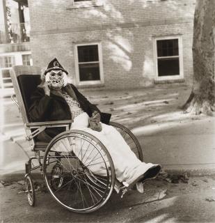 Diane Arbus - Masked woman in a wheelchair, PA, 1970