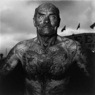 Diane Arbus - Tattooed Man at a Carnival, MD (1970)
