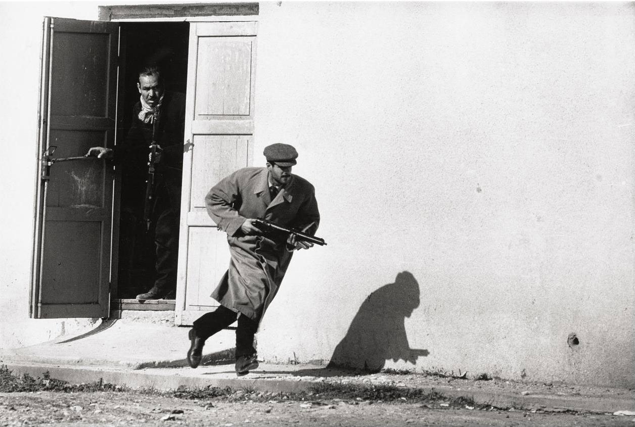 Don Mccullin - Turkish Cypriot sprinting from a cinema door under fire, Limassol, Cyprus, 1964