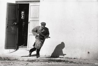 Don Mccullin - Turkish Cypriot sprinting from a cinema door under fire, Limassol, Cyprus, 1964