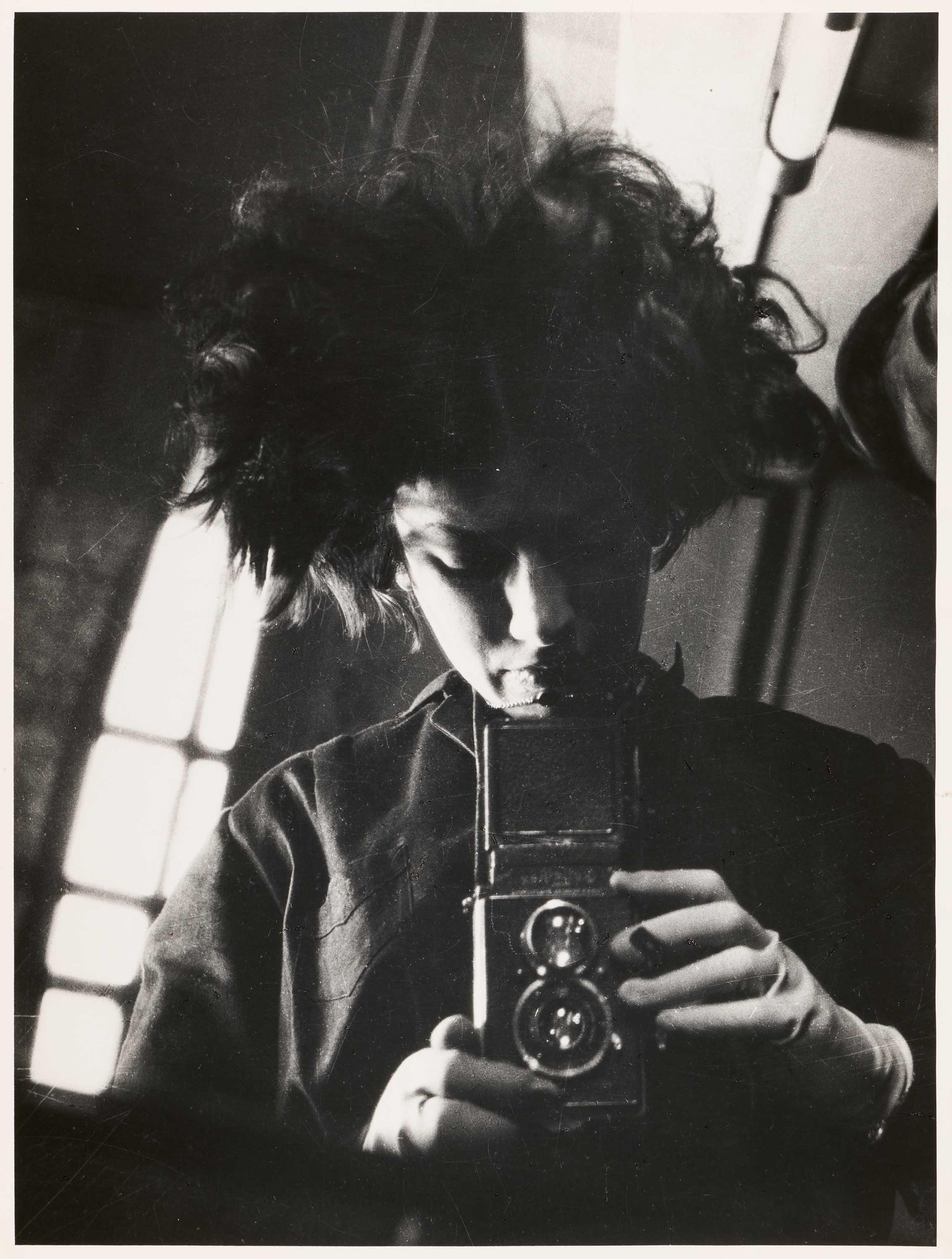 Eva Besnyö - Selfportrait with camera.