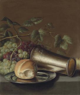Floris van Schooten - Bread on a pewter platter, an engraved silver cup, with grapes and a plum on a stone ledge