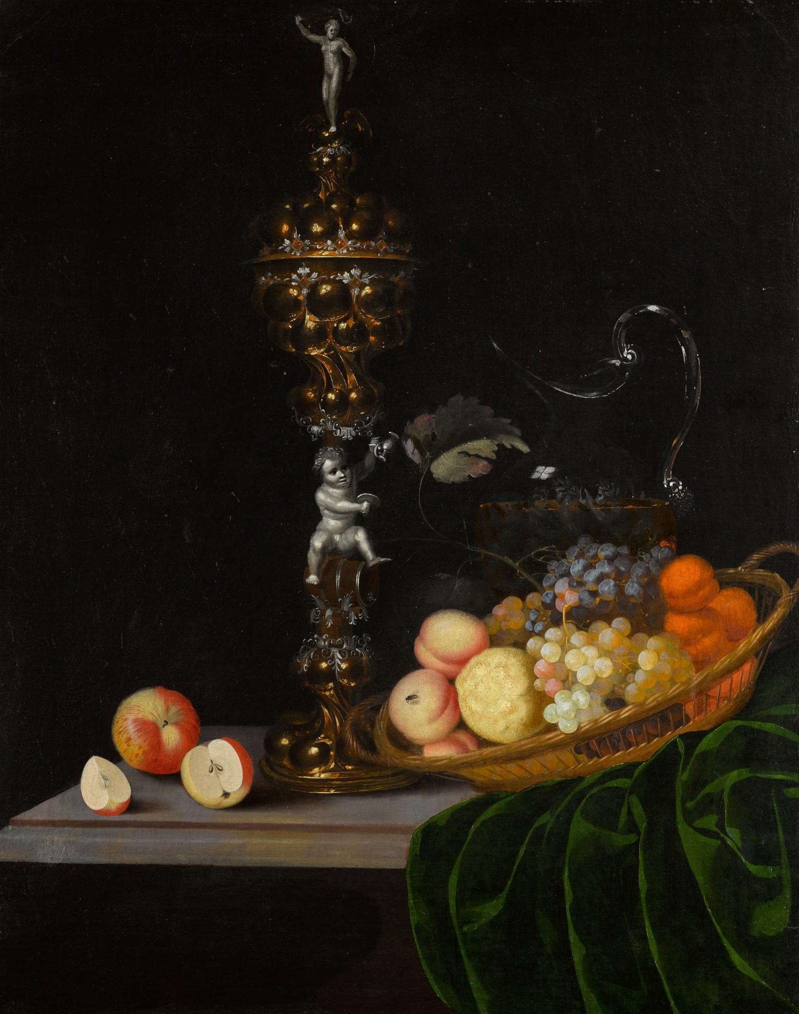 Georg Hinz - Still life with an elaborate silver gilt standing cup, a basket of fruit, and a glass wine jug upon a partly draped table