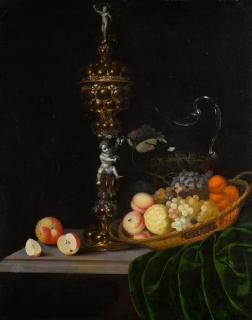 Georg Hinz - Still life with an elaborate silver gilt standing cup, a basket of fruit, and a glass wine jug upon a partly draped table