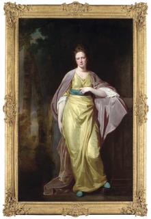George Romney - Portrait of Mrs Ellen Morewood, Full-Length, In A Yellow Dress With A Blue Sash And A Mauve Wrap, Leaning On A Pedestal, In A Wooded Landscape