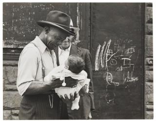 Helen Levitt - New York City (Man holding baby), c. 1939