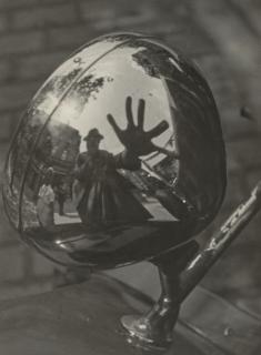 Imre Kinszki - Self-Portrait in Reflection of Car Headlight, c. 1930