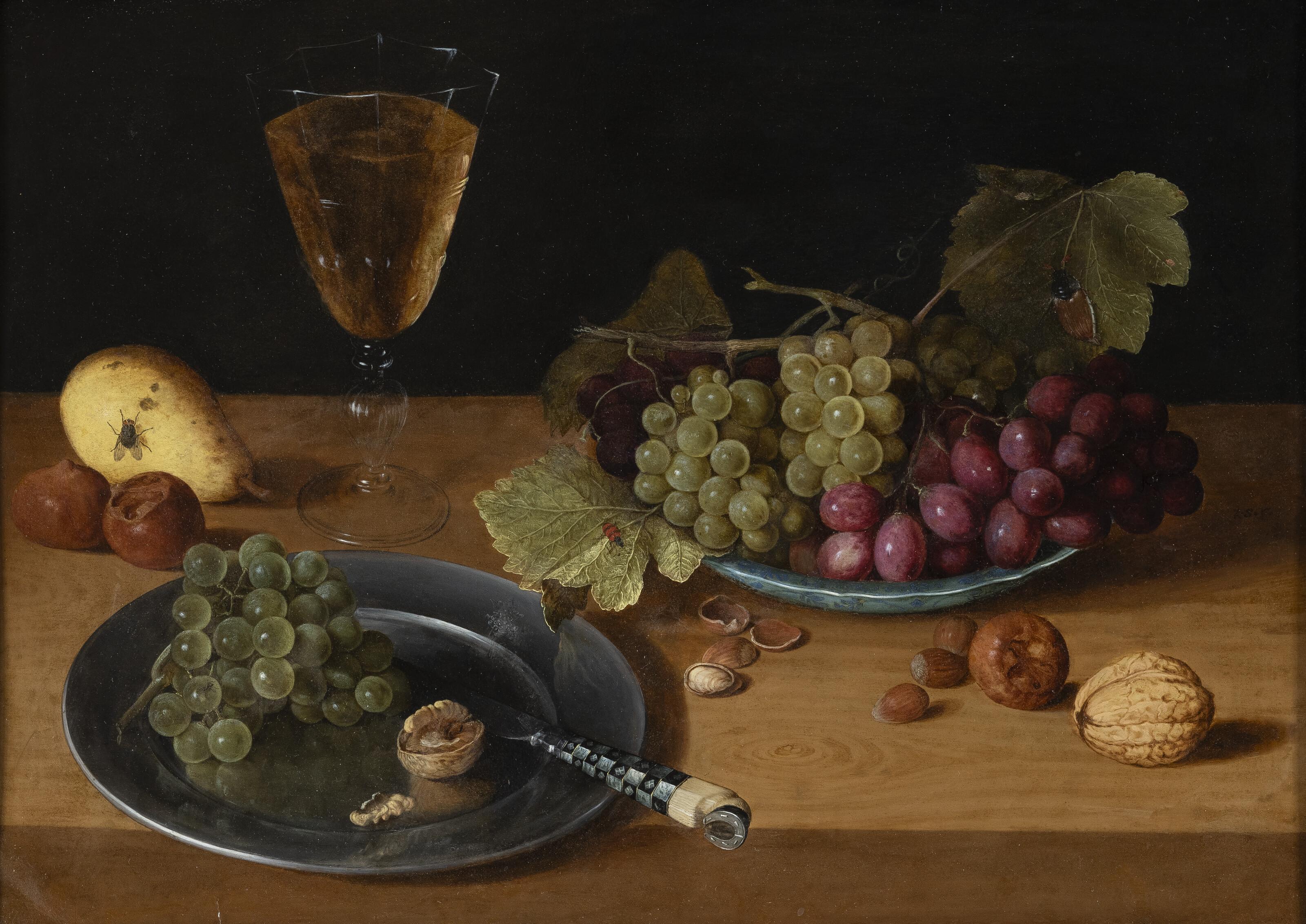 Isaac Soreau - A porcelain plate with red and green grapes, a pewter plate with a knife, nuts, a pear and a glass of wine on a table top