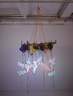 Jason Rhoades - Two-Wheel wagon-wheel chandelier (Tongue Magnet, Bag of Tricks, Cum Craver, Lites Dainty, Hootchie, Pootie Poo, Illnana, Pink Mink, Dogs Mouth)