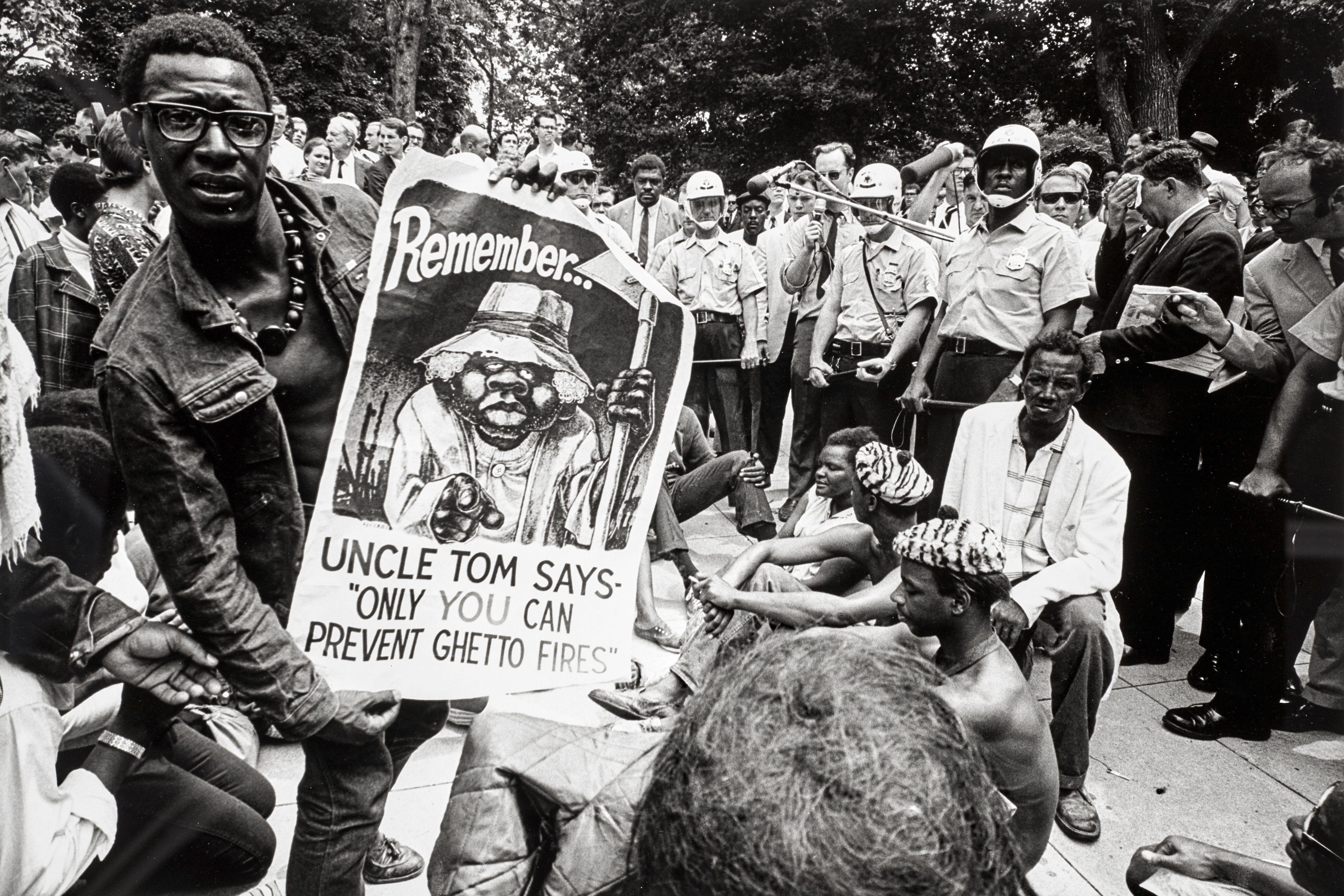 Jill Freedman - (Demonstrator with Uncle Tom poster), Resurrection City, Poor People\'s Campaign, Washington, DC