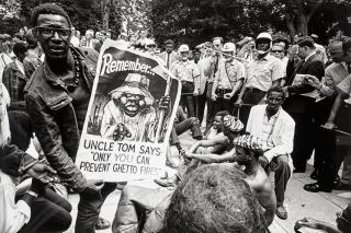Jill Freedman - (Demonstrator with Uncle Tom poster), Resurrection City, Poor People\'s Campaign, Washington, DC