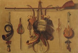 Johannes Leemans - A \'trompe l\'oeil\' still life with hunting paraphernalia hanging on a wall