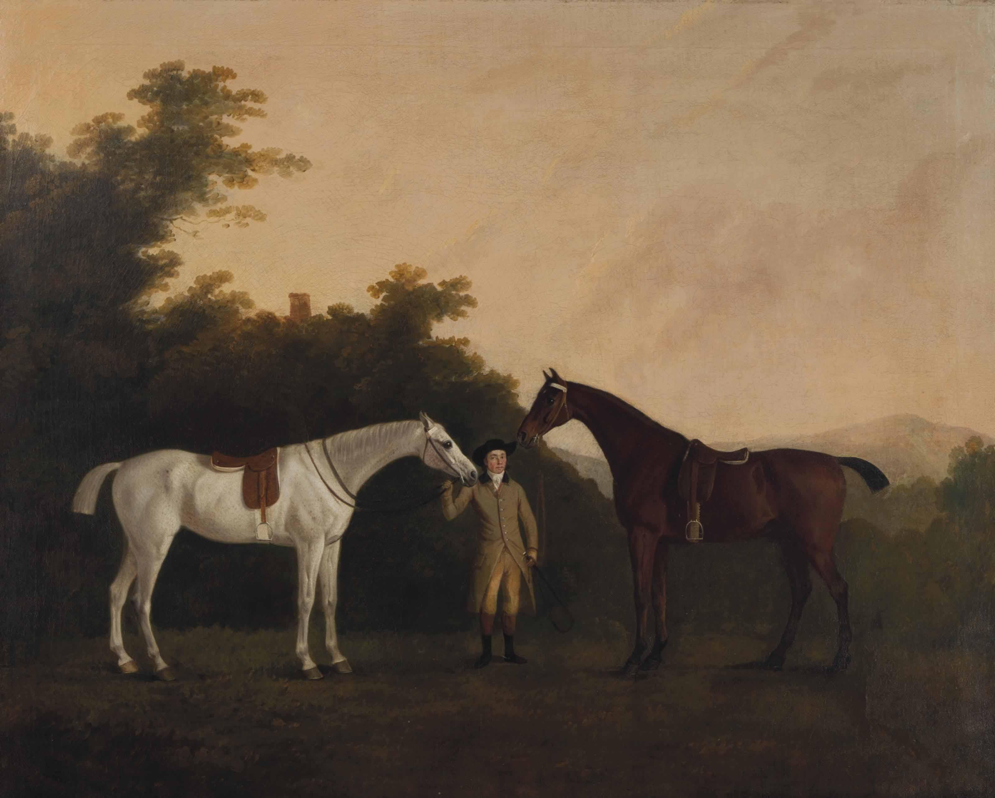 John Boultbee - A Groom Holding A Grey And A Dark Bay Hunters In A Wooded Landscape, A Tower Beyond
