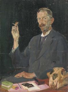 John David Revel, R.O.I. - Portrait of a gentleman, seated three-quarter-length, in a dark grey suit, smoking a cigarette, with a skull on a table before him