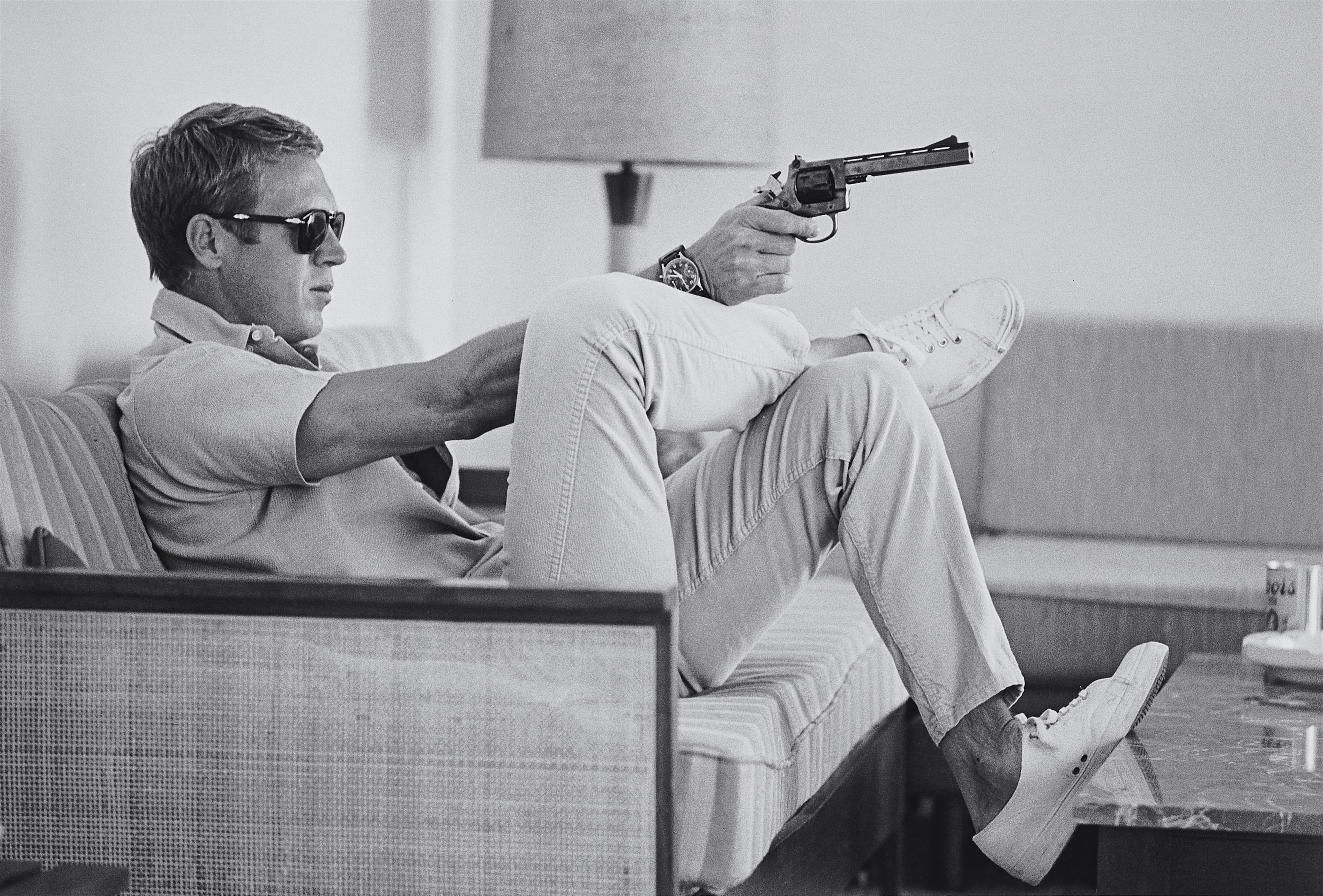 John Dominis - Steve McQueen Aims a Pistol in His Living Room, CA