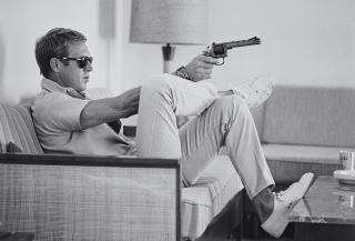 John Dominis - Steve McQueen Aims a Pistol in His Living Room, CA