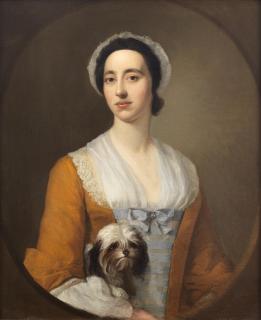 Joseph Highmore - Portrait Of A Lady, Half-Length, In An Orange Dress Holding A Dog, Within A Painted Oval