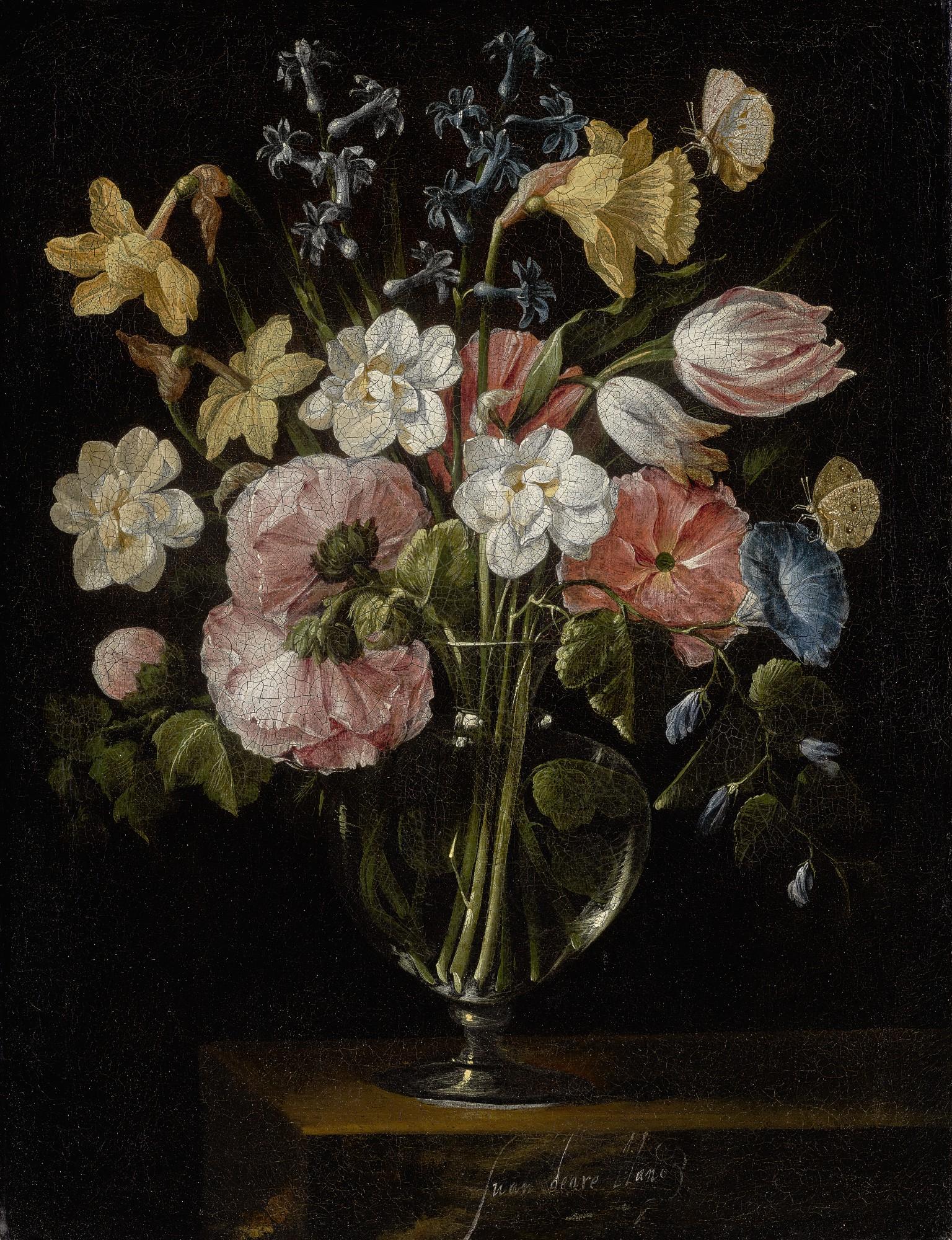 Juan De Arellano - A Still Life Of Narcissi, Daffodils, Tulips, Hollyhocks, Hyacinths And Other Flowers In A Glass Vase On A Stone Ledge, With Butterflies