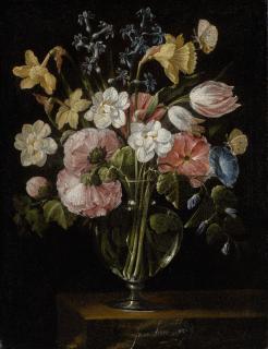 Juan De Arellano - A Still Life Of Narcissi, Daffodils, Tulips, Hollyhocks, Hyacinths And Other Flowers In A Glass Vase On A Stone Ledge, With Butterflies