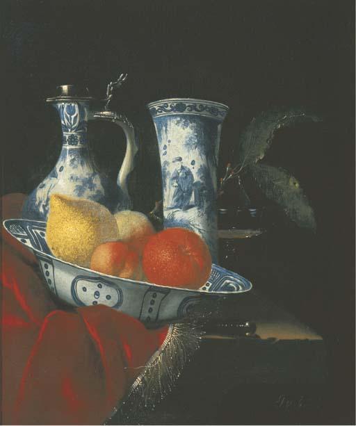 Juriaen Van Streek - A blue and white Wan-li klapmuts bowl with peaches, a lemon and an orange, a silver-mounted Transitional ewer, a beaker, a glass tazza and a knife on a partly-draped stone ledge