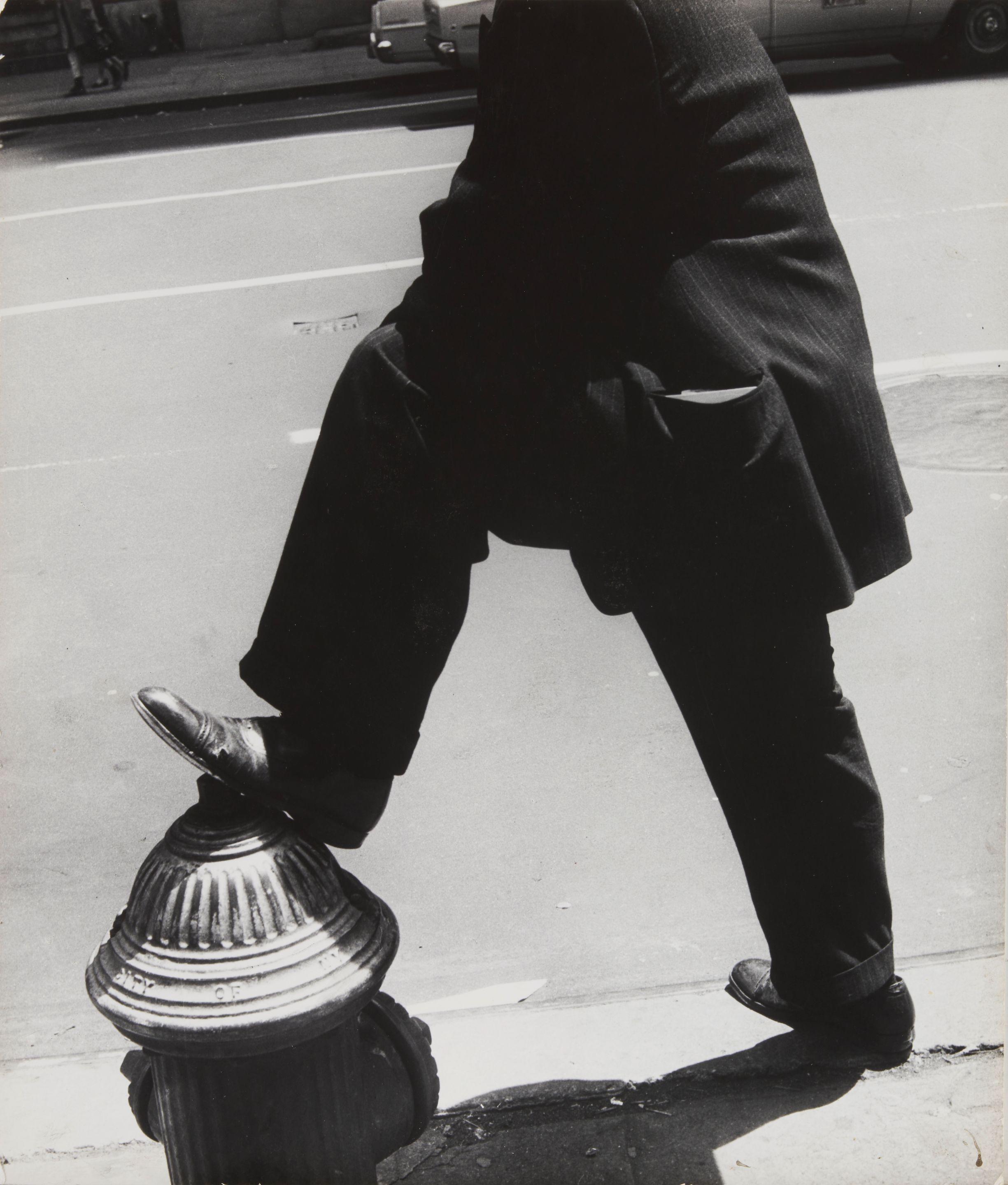 Leon Levinstein - NYC [man resting his foot on a fire hydrant]