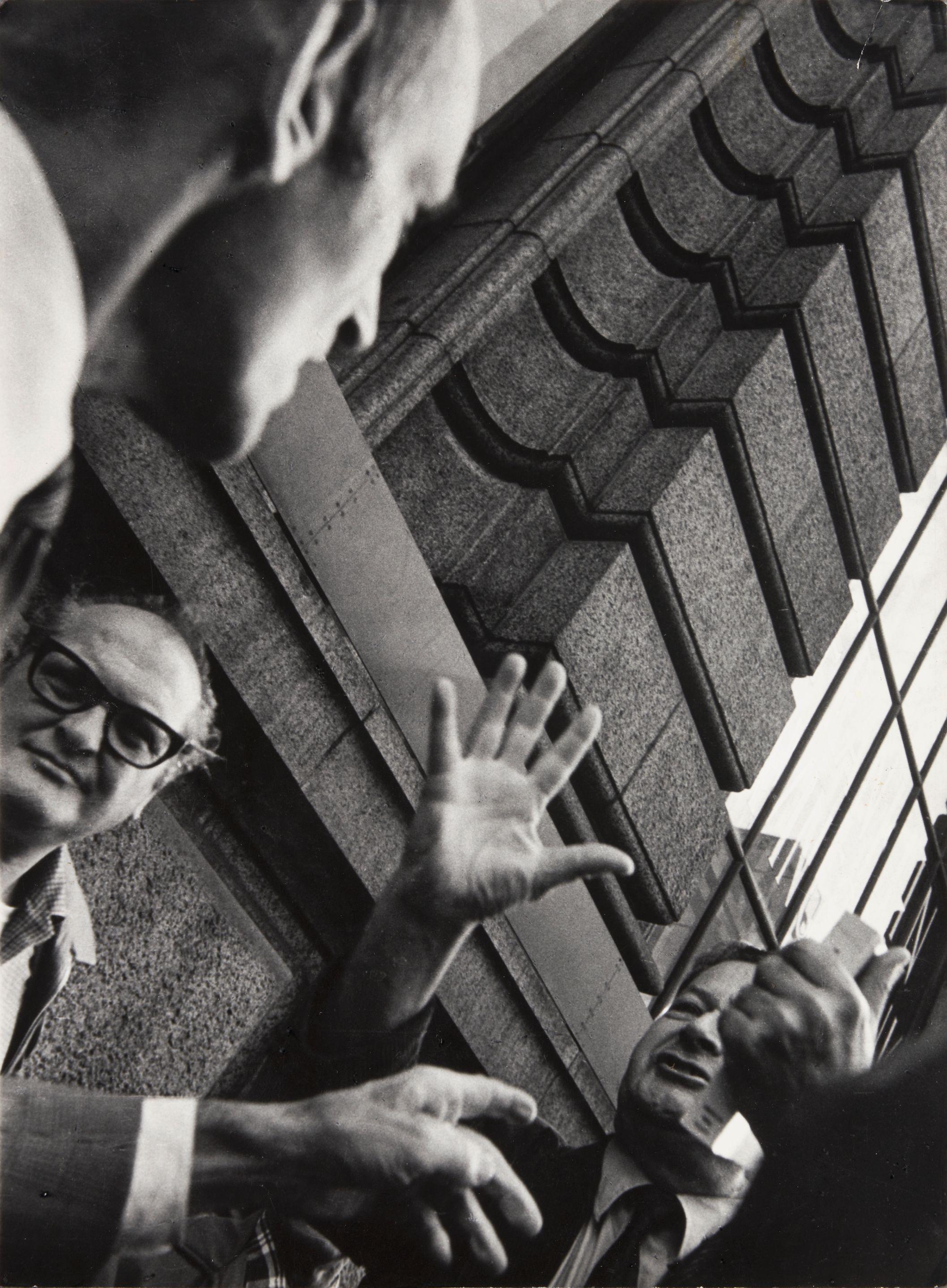 Leon Levinstein - Untitled, New York [street scene, men with hands raised]