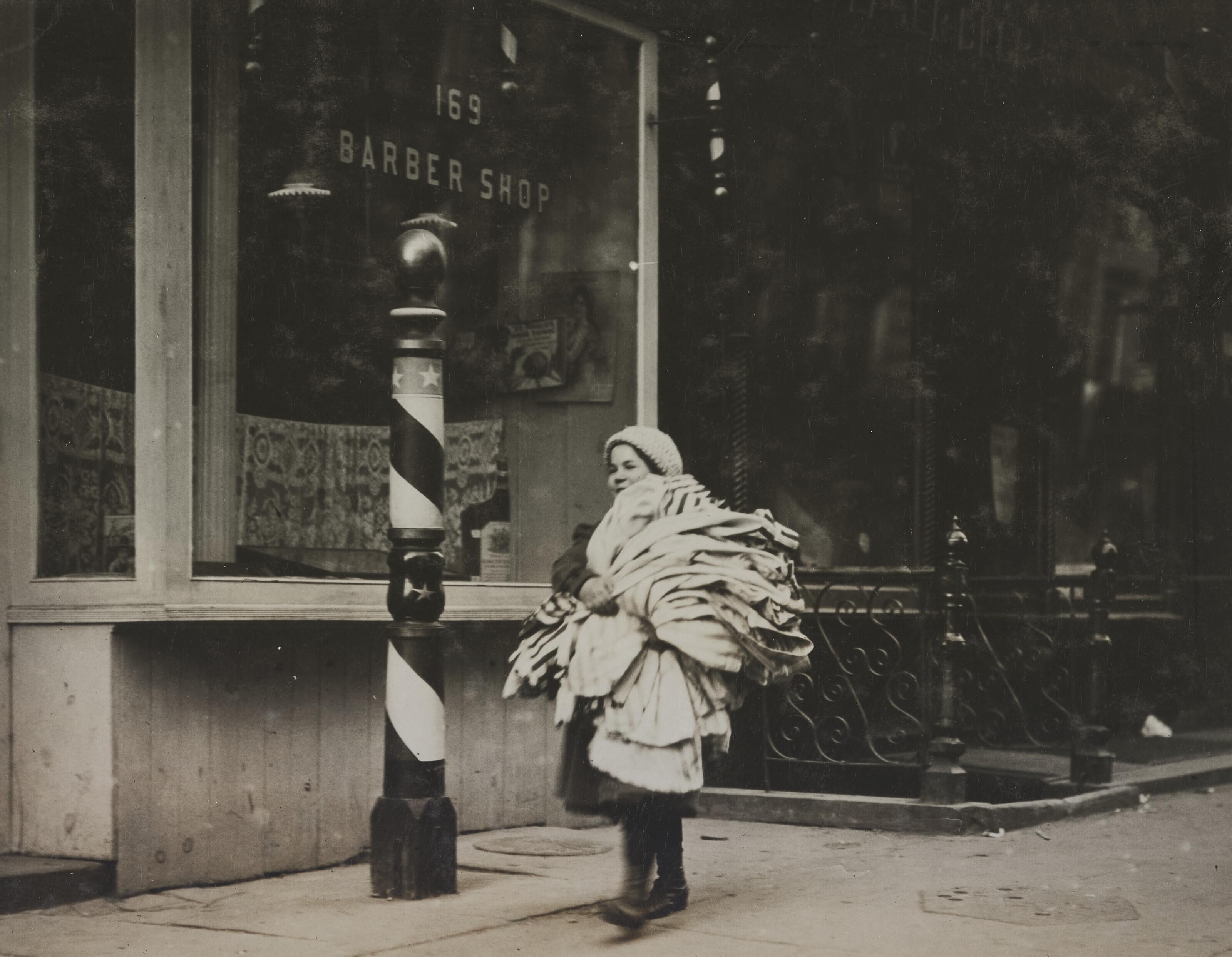 Lewis W. Hine - A load of kimonos just finished. Girl very reticent. Thompson St., N.Y., February 10, 1912
