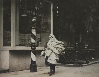 Lewis W. Hine - A load of kimonos just finished. Girl very reticent. Thompson St., N.Y., February 10, 1912