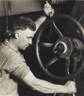 Lewis W. Hine - An Industrial Design: Pennsylvania Rubber Co. At the control wheel of a great \'calendar\' - making auto tires, 1920s
