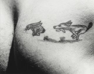 Lou Stoumen - Dog chasing rabbit into hole: Tattoo Aboard US Mission bay, South Atlantic