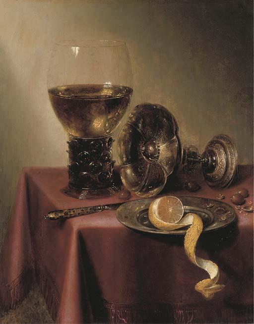 Maerten Boelema de Stomme - An Upturned Silver Tazza, Hazelnuts, A Peeled Lemon On A Pewter Platter, A Knife And A Roemer, On A Draped Table