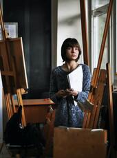 Woman standing in front of an easel