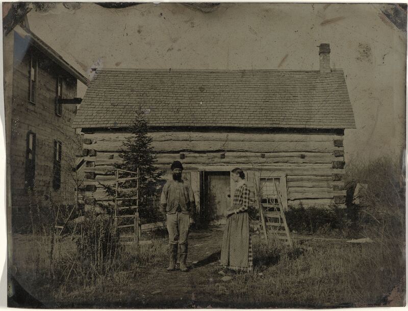 Anonymous, View on a wooden house or barn with a man and a woman in front, c. 1870-1875