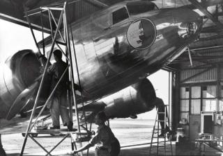 Margaret Bourke-White - Eastern Airlines plane being worked on in hangar; and U.S. Mail plane, Atlanta