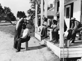 Marion Post Wolcott - Negroes cut each others hair in front of plantation store after being paid off on Saturday, Milestone Plantation, Mississippi Delta
