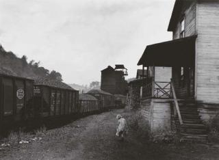 Marion Post Wolcott - Unemployed miner\'s daughter carrying home can of kerosene past company housing, Scottsrun, W. Va.