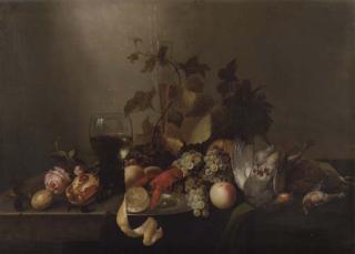 Michiel Simons - A rose, a pomegranate, a glass flute, grapes, a partly peeled lemon on a silver plate, a roemer, a lobster, peaches, a pheasant and other birds on a partly-draped table