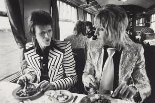 Mick Rock - David Bowie And Mick Ronson, Lunch On Train To Aberdeen, Scotland, 1973