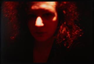 Nan Goldin - Self-portrait, red, Zurich.