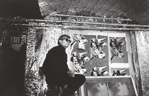 Nat Finkelstein - Andy Warhol sitting in front of his cow silkscreens