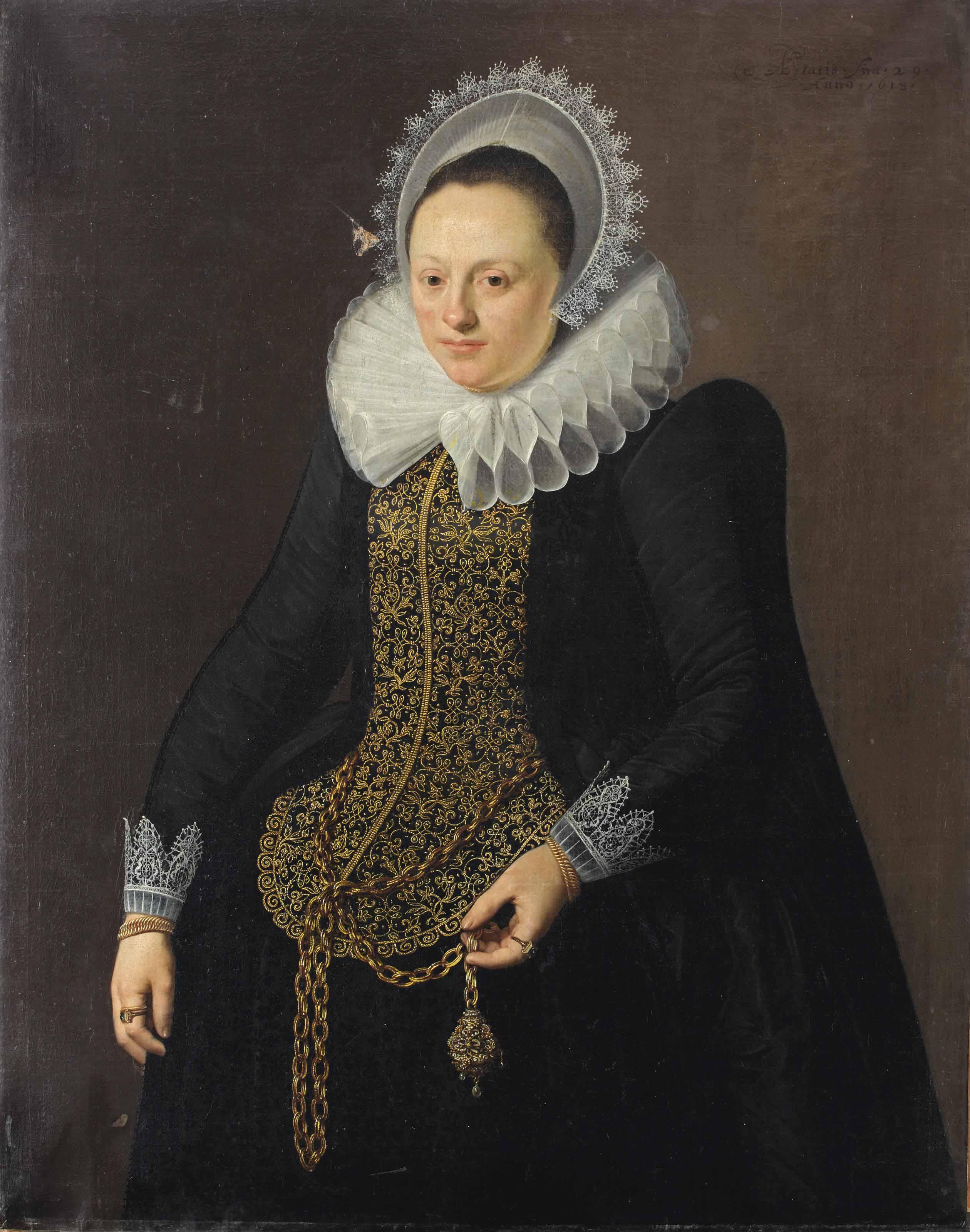 Nicolaes Eliasz. Pickenoy - Portrait of a lady, three-quarter length, in a black dress with white lace collar and lace headdress, with gold embroided bodice, holding a gold chain with a pendant in her left hand